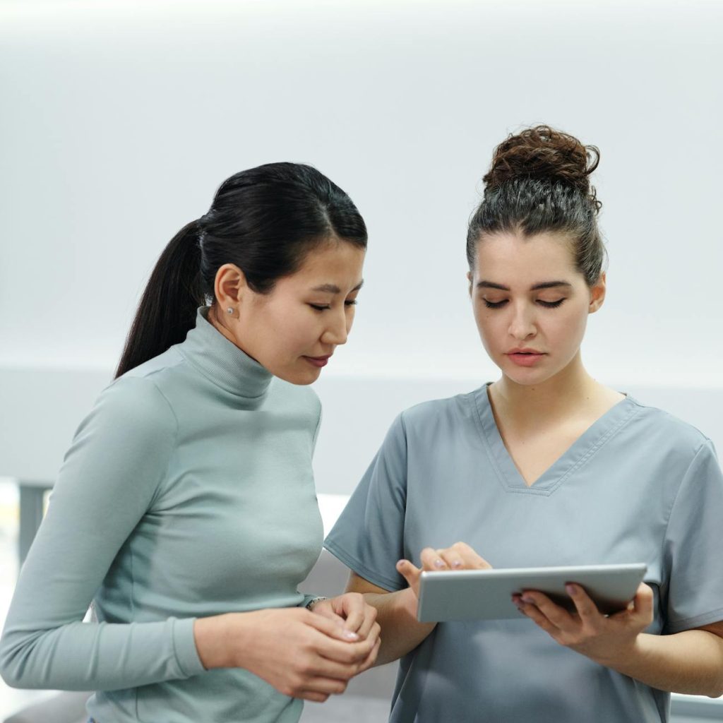 A Doctor and a Patient Looking at a Tablet
